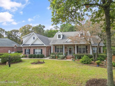 This beautiful home is nestled on a completely landscaped wooded on Lockwood Folly Country Club in North Carolina - for sale on GolfHomes.com, golf home, golf lot