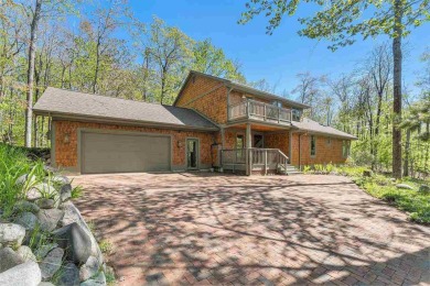 Perched at the crest of a wooded hill, this distinctive on Birchwood Farms Golf and Country Club in Michigan - for sale on GolfHomes.com, golf home, golf lot
