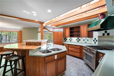 Perched at the crest of a wooded hill, this distinctive on Birchwood Farms Golf and Country Club in Michigan - for sale on GolfHomes.com, golf home, golf lot
