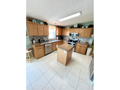 Move right into this furnished two-bedroom, two-bath home on Pine Lakes Country Club in Florida - for sale on GolfHomes.com, golf home, golf lot