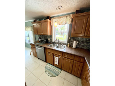 Move right into this furnished two-bedroom, two-bath home on Pine Lakes Country Club in Florida - for sale on GolfHomes.com, golf home, golf lot