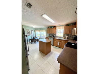 Move right into this furnished two-bedroom, two-bath home on Pine Lakes Country Club in Florida - for sale on GolfHomes.com, golf home, golf lot