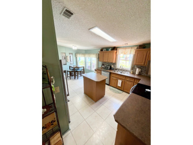 Move right into this furnished two-bedroom, two-bath home on Pine Lakes Country Club in Florida - for sale on GolfHomes.com, golf home, golf lot