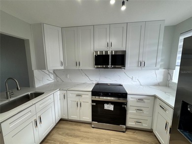 Luxury fully renovated 2BR/2BA golf course and lake view condo on Feather Sound Country Club in Florida - for sale on GolfHomes.com, golf home, golf lot