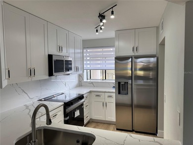 Luxury fully renovated 2BR/2BA golf course and lake view condo on Feather Sound Country Club in Florida - for sale on GolfHomes.com, golf home, golf lot