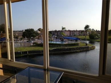 MILLION-DOLLAR VIEWS OF THE LAKE, GOLF COURSES, AND THE on Sunrise Lakes Phase III in Florida - for sale on GolfHomes.com, golf home, golf lot