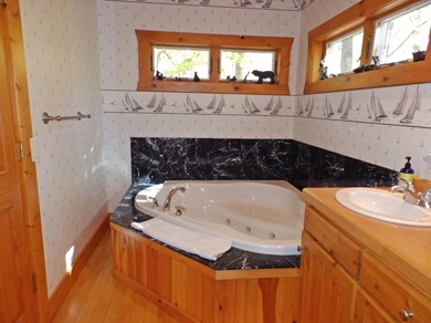 Welcome to this beautifully maintained Northern Michigan getaway on Michaywe Pines Course in Michigan - for sale on GolfHomes.com, golf home, golf lot