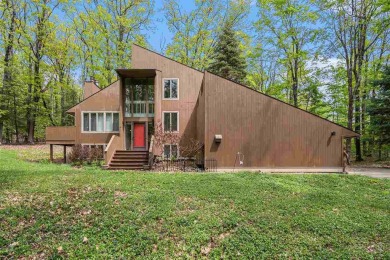 Nestled on a serene, wooded lot and backing up to protected on Birchwood Farms Golf and Country Club in Michigan - for sale on GolfHomes.com, golf home, golf lot