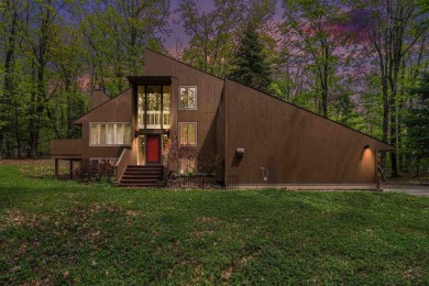Nestled on a serene, wooded lot and backing up to protected on Birchwood Farms Golf and Country Club in Michigan - for sale on GolfHomes.com, golf home, golf lot