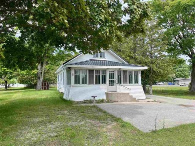 Cottage style home on Residential / Commercial lot. Located next on Charlevoix Golf Club in Michigan - for sale on GolfHomes.com, golf home, golf lot
