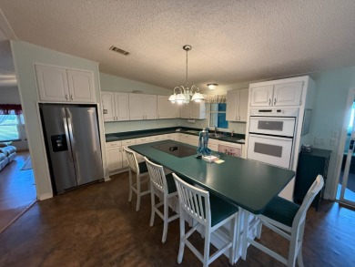 This well-cared for home is being sold furnished.  It is located on Del Tura Golf and Country Club in Florida - for sale on GolfHomes.com, golf home, golf lot