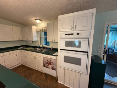 This well-cared for home is being sold furnished.  It is located on Del Tura Golf and Country Club in Florida - for sale on GolfHomes.com, golf home, golf lot
