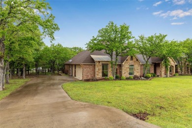 Nestled amidst the serene beauty of mature oak trees, this home on Sugar Tree Golf and Country Club in Texas - for sale on GolfHomes.com, golf home, golf lot