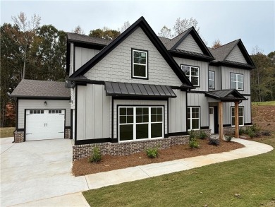 Stunning 2-story home with a 3rd car garage in a coveted on Traditions of Braselton Golf Club in Georgia - for sale on GolfHomes.com, golf home, golf lot