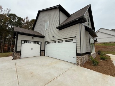 Stunning 2-story home with a 3rd car garage in a coveted on Traditions of Braselton Golf Club in Georgia - for sale on GolfHomes.com, golf home, golf lot