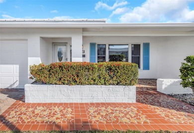 The oversized covered front porch welcomes you into this on Mainlands Golf Club in Florida - for sale on GolfHomes.com, golf home, golf lot