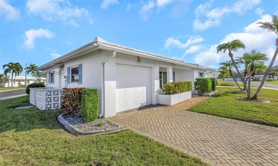 The oversized covered front porch welcomes you into this on Mainlands Golf Club in Florida - for sale on GolfHomes.com, golf home, golf lot
