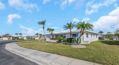 The oversized covered front porch welcomes you into this on Mainlands Golf Club in Florida - for sale on GolfHomes.com, golf home, golf lot