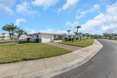 The oversized covered front porch welcomes you into this on Mainlands Golf Club in Florida - for sale on GolfHomes.com, golf home, golf lot