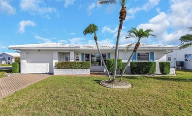 The oversized covered front porch welcomes you into this on Mainlands Golf Club in Florida - for sale on GolfHomes.com, golf home, golf lot