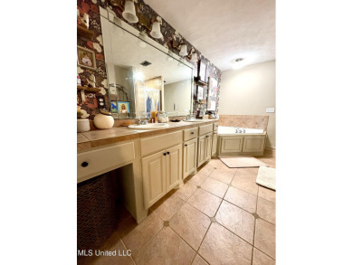 Beautifully updated 4 bedroom home is walking distance to the on Castlewoods Golf Club in Mississippi - for sale on GolfHomes.com, golf home, golf lot