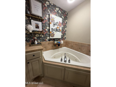 Beautifully updated 4 bedroom home is walking distance to the on Castlewoods Golf Club in Mississippi - for sale on GolfHomes.com, golf home, golf lot