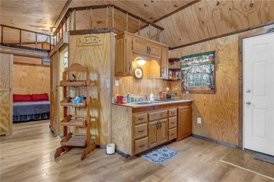 Enjoy lakeside living with this charming and move-in ready cabin on Sugar Valley Lakes Golf Course in Kansas - for sale on GolfHomes.com, golf home, golf lot