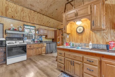 Enjoy lakeside living with this charming and move-in ready cabin on Sugar Valley Lakes Golf Course in Kansas - for sale on GolfHomes.com, golf home, golf lot