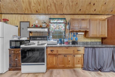 Enjoy lakeside living with this charming and move-in ready cabin on Sugar Valley Lakes Golf Course in Kansas - for sale on GolfHomes.com, golf home, golf lot