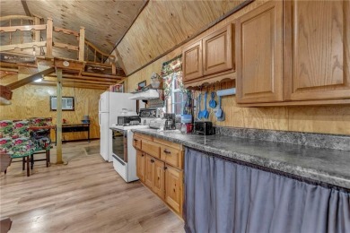 Enjoy lakeside living with this charming and move-in ready cabin on Sugar Valley Lakes Golf Course in Kansas - for sale on GolfHomes.com, golf home, golf lot