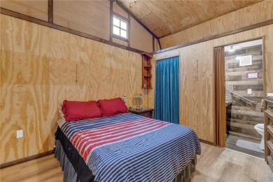 Enjoy lakeside living with this charming and move-in ready cabin on Sugar Valley Lakes Golf Course in Kansas - for sale on GolfHomes.com, golf home, golf lot