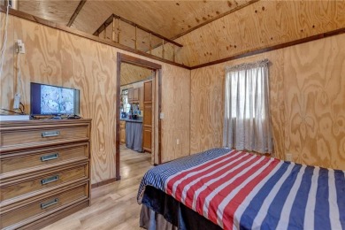 Enjoy lakeside living with this charming and move-in ready cabin on Sugar Valley Lakes Golf Course in Kansas - for sale on GolfHomes.com, golf home, golf lot