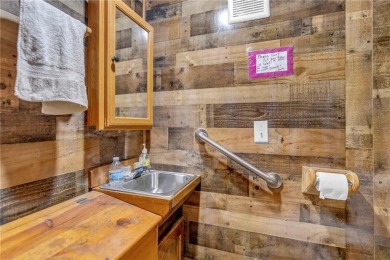 Enjoy lakeside living with this charming and move-in ready cabin on Sugar Valley Lakes Golf Course in Kansas - for sale on GolfHomes.com, golf home, golf lot
