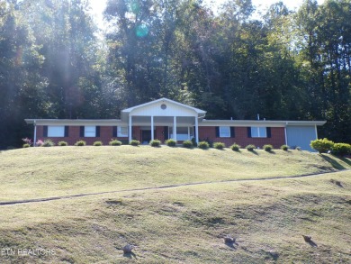 Sit on your front porch and love the Eastern Kentucky fall views on Wasioto Winds in Kentucky - for sale on GolfHomes.com, golf home, golf lot