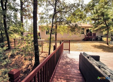 Special setting in Tahitian Village! 2016 built home overlooks a on Pine Forest Golf Club in Texas - for sale on GolfHomes.com, golf home, golf lot