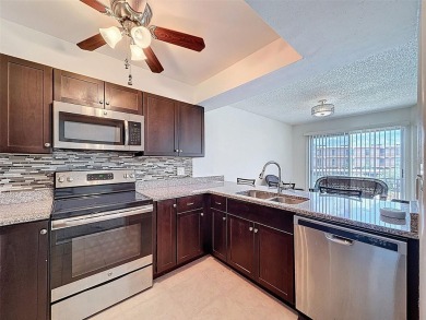 Discover this charming two-bedroom, two-bathroom condo in the on East Bay Golf Club in Florida - for sale on GolfHomes.com, golf home, golf lot