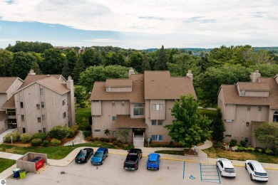 Perched above the third tee of Spruce Run Golf Course, this on Grand Traverse Resort and Spa in Michigan - for sale on GolfHomes.com, golf home, golf lot