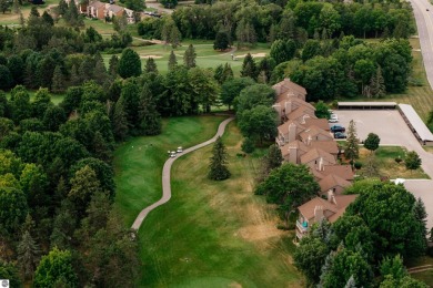 Perched above the third tee of Spruce Run Golf Course, this on Grand Traverse Resort and Spa in Michigan - for sale on GolfHomes.com, golf home, golf lot