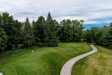 Perched above the third tee of Spruce Run Golf Course, this on Grand Traverse Resort and Spa in Michigan - for sale on GolfHomes.com, golf home, golf lot