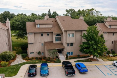 Perched above the third tee of Spruce Run Golf Course, this on Grand Traverse Resort and Spa in Michigan - for sale on GolfHomes.com, golf home, golf lot