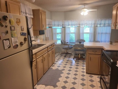 2/2 home has open floor plan. Large eat-in kitchen has lots of on Lake Henry Golf Club in Florida - for sale on GolfHomes.com, golf home, golf lot