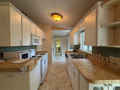 Spacious 2-bedroom, 3-bathroom home located in the active 55+ on Royal Oaks Golf Club in Florida - for sale on GolfHomes.com, golf home, golf lot
