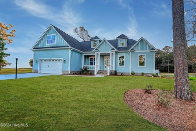 Step into paradise at 115 Genoes Point Road SW, where coastal on Lockwood Folly Country Club in North Carolina - for sale on GolfHomes.com, golf home, golf lot