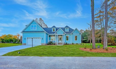 Step into paradise at 115 Genoes Point Road SW, where coastal on Lockwood Folly Country Club in North Carolina - for sale on GolfHomes.com, golf home, golf lot