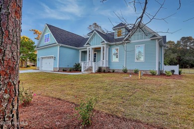 Step into paradise at 115 Genoes Point Road SW, where coastal on Lockwood Folly Country Club in North Carolina - for sale on GolfHomes.com, golf home, golf lot