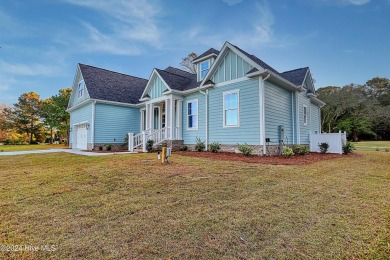 Step into paradise at 115 Genoes Point Road SW, where coastal on Lockwood Folly Country Club in North Carolina - for sale on GolfHomes.com, golf home, golf lot