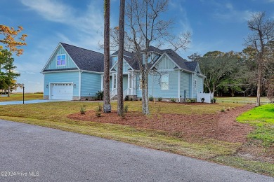 Step into paradise at 115 Genoes Point Road SW, where coastal on Lockwood Folly Country Club in North Carolina - for sale on GolfHomes.com, golf home, golf lot