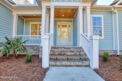 Step into paradise at 115 Genoes Point Road SW, where coastal on Lockwood Folly Country Club in North Carolina - for sale on GolfHomes.com, golf home, golf lot