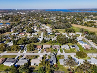 Welcome to a Retreat in Charm at 122 Stafford Dr., Palm Harbor on Highland Lakes Executive Golf Course in Florida - for sale on GolfHomes.com, golf home, golf lot