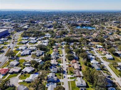 Welcome to a Retreat in Charm at 122 Stafford Dr., Palm Harbor on Highland Lakes Executive Golf Course in Florida - for sale on GolfHomes.com, golf home, golf lot